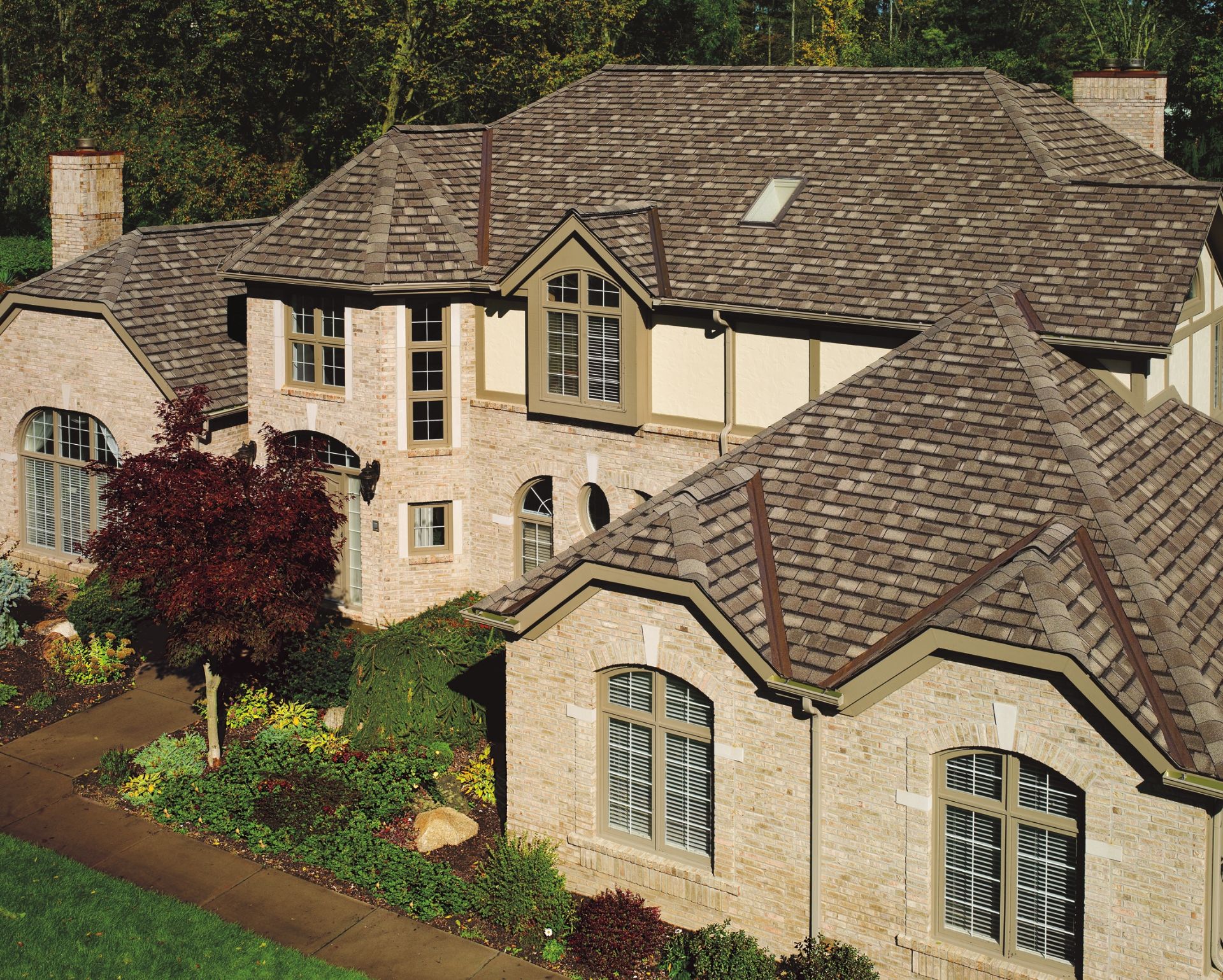 A large home with new asphalt shingle roofing.